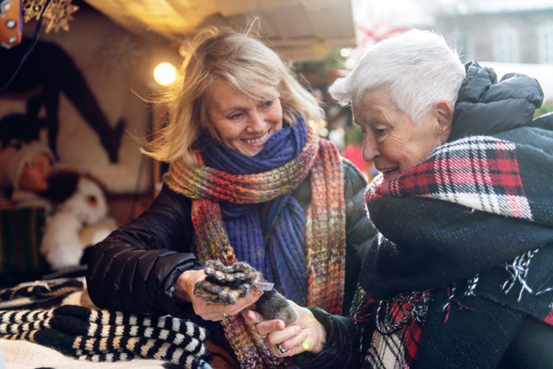 happy caregiver shoppig with senior lady